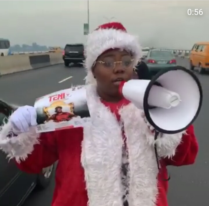 Teni Rocks Father Christmas Costume, Begs People On The Road To Come To Her Show 5